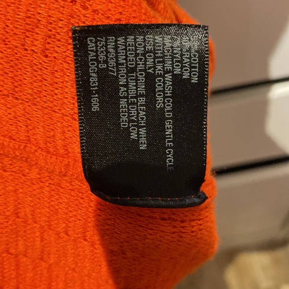 The orange sleeveless top with a peplum finish on the bottom and keyhole bac - Picture 3 of 3